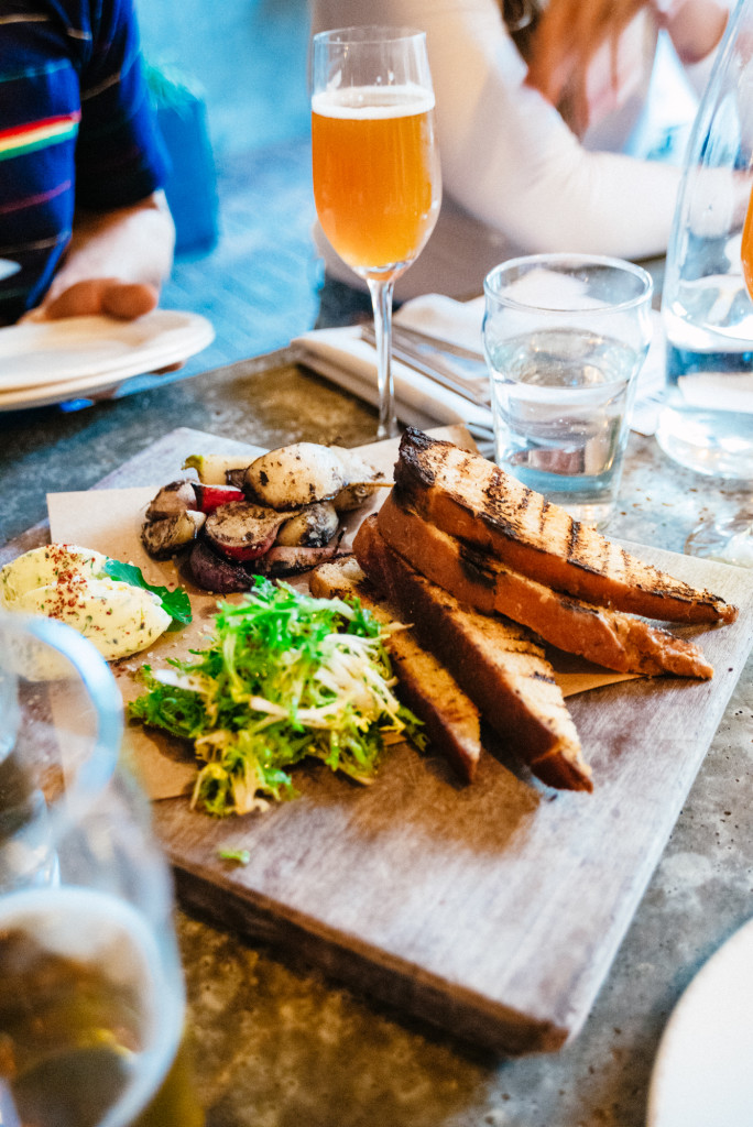 Course 1: Rye bread, beef fat butter, grilled radish, turnips, greens Beer: Bayerischer Bahnhof Gewürz Gose