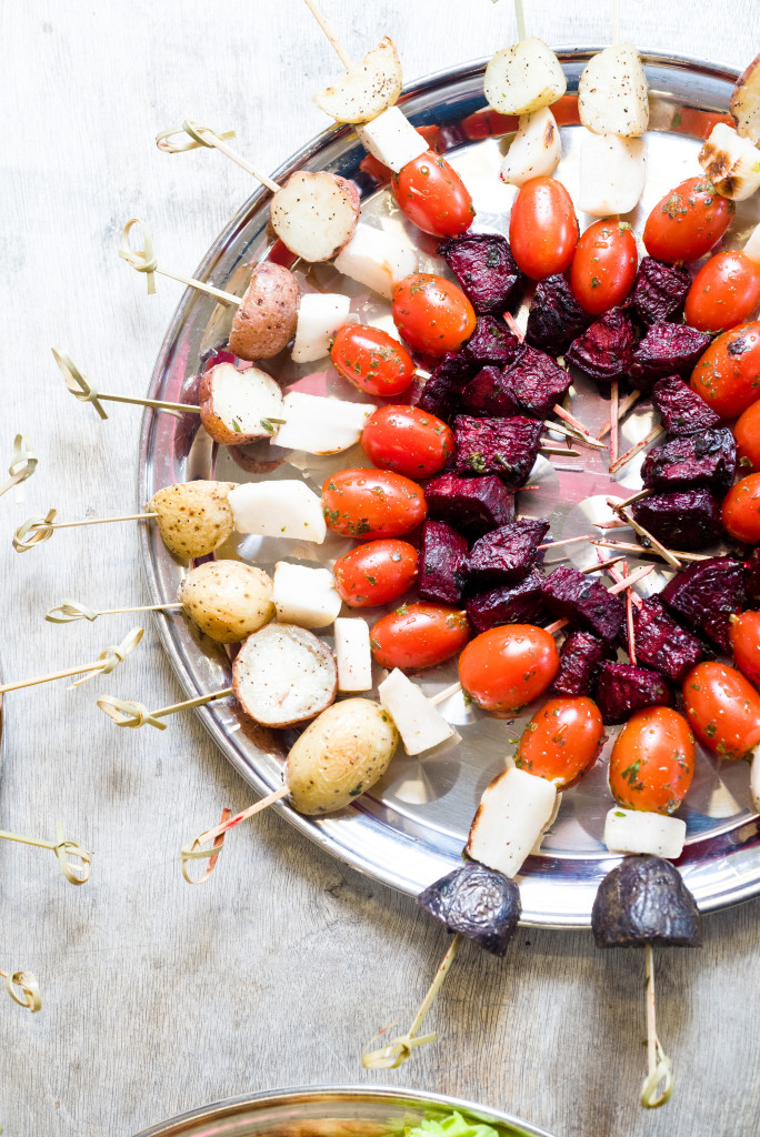 Colorful vegetable skewers or kabobs on a silver tray at a party.